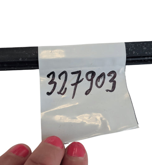 Clear plastic bag with handwritten numbers '327903' held by a hand with pink nail polish.